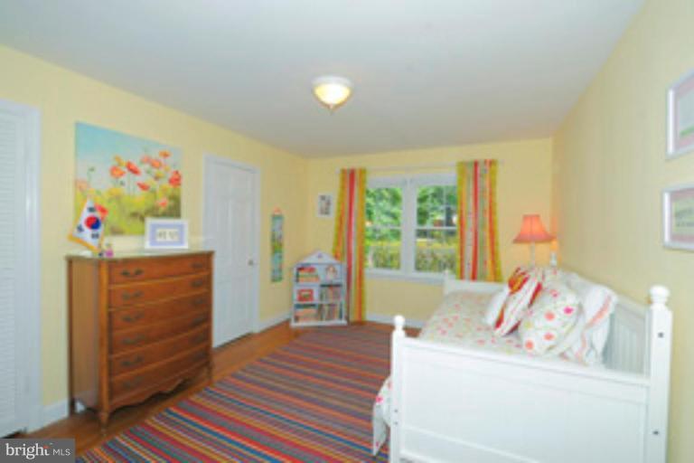 5807 Overlea Road Bethesda, MD 20816 - Photo 15 of 23 a bedroom with a bed and wooden floor
