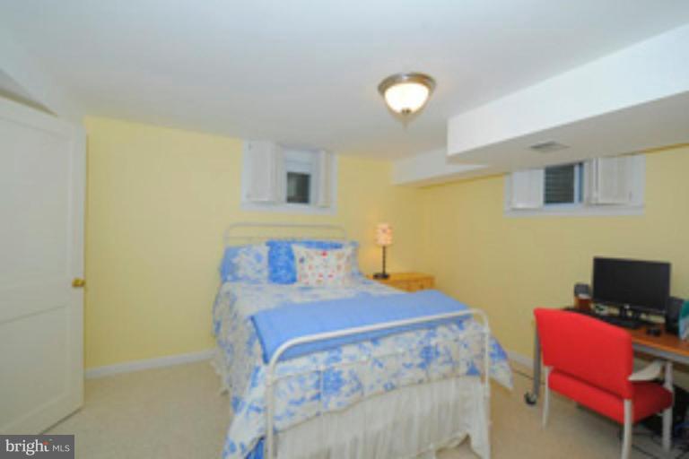5807 Overlea Road Bethesda, MD 20816 - Photo 16 of 23 a bedroom with a bed and a chair