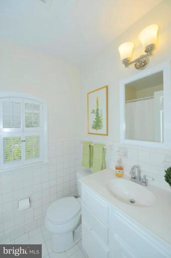 5807 Overlea Road Bethesda, MD 20816 - Photo 17 of 23 a bathroom with a sink toilet and window