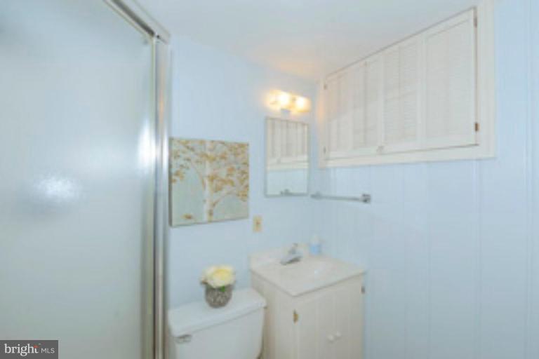 5807 Overlea Road Bethesda, MD 20816 - Photo 18 of 23 a bathroom with a sink toilet and vanity