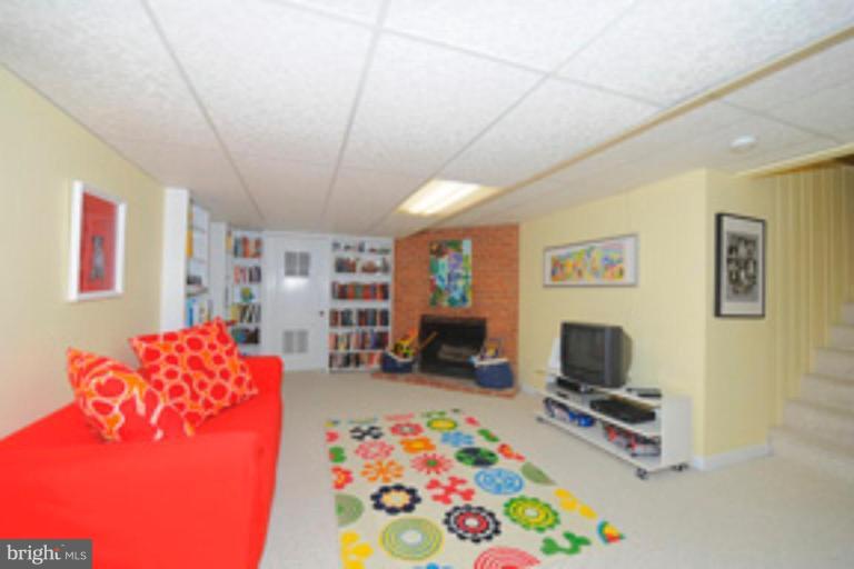 5807 Overlea Road Bethesda, MD 20816 - Photo 20 of 23 a bedroom with furniture and a flat screen tv