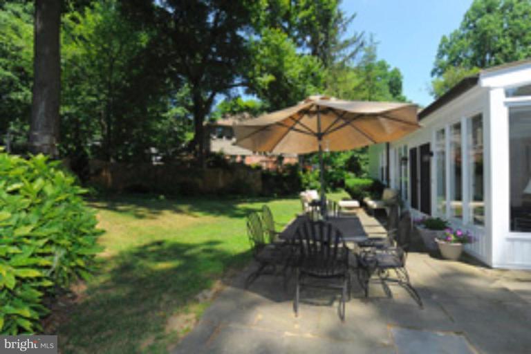 5807 Overlea Road Bethesda, MD 20816 - Photo 21 of 23 a view of patio with a table and chairs under an umbrella