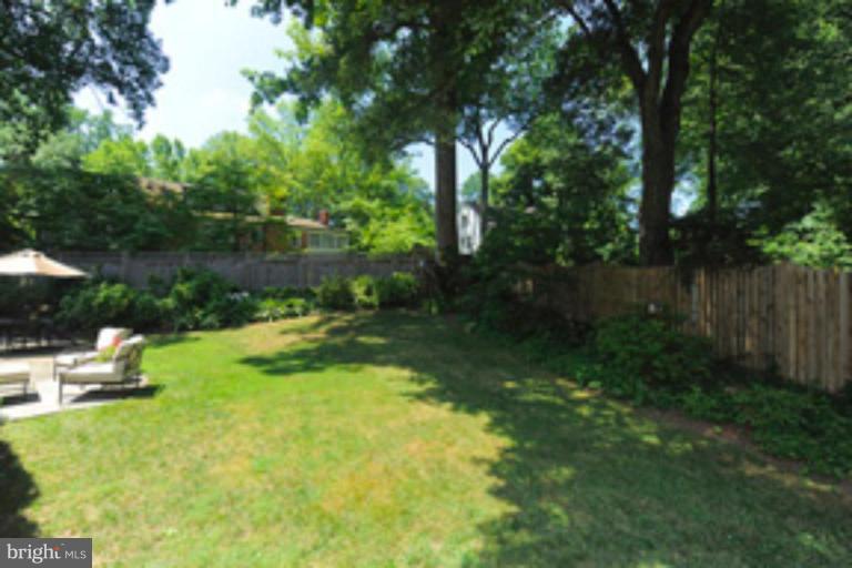 5807 Overlea Road Bethesda, MD 20816 - Photo 23 of 23 a view of a lake with a bench and trees around