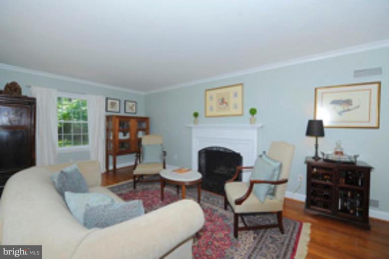 5807 Overlea Road Bethesda, MD 20816 - Photo 4 of 23 a living room with furniture and a fireplace
