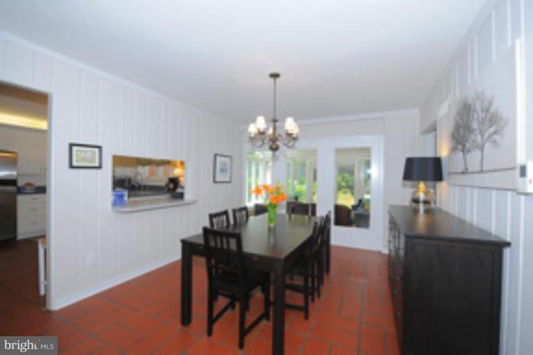 5807 Overlea Road Bethesda, MD 20816 - Photo 7 of 23 a view of a dining room with furniture and chandelier