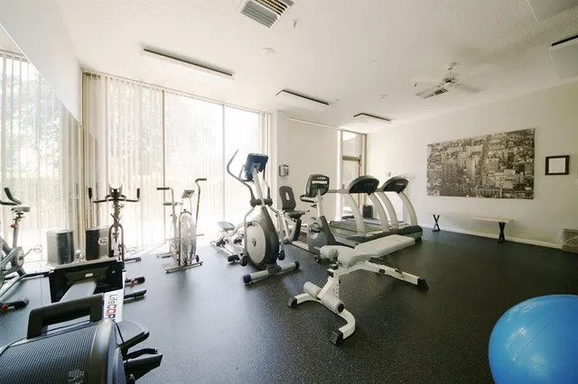 a front view of a house with a yard and fountain in middle