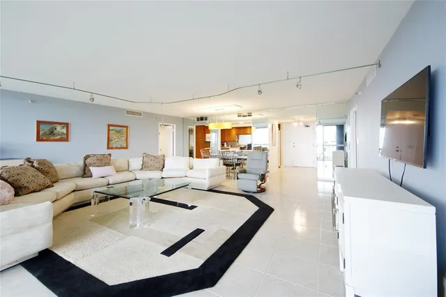 a living room with couches and a flat screen tv