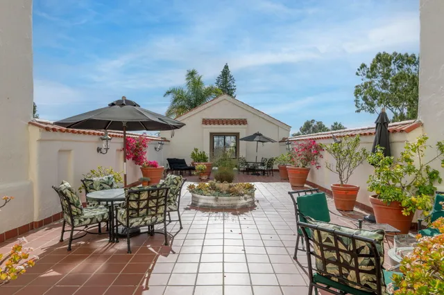 a view of a patio with table and chairs potted plants