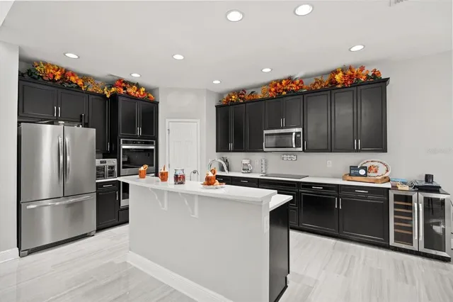 a kitchen with stainless steel appliances a sink stove top oven and refrigerator