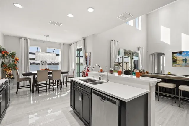 a room with furniture a sink a counter top space and a dining table