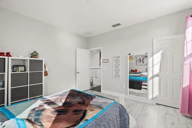 a bedroom with a bed and a television