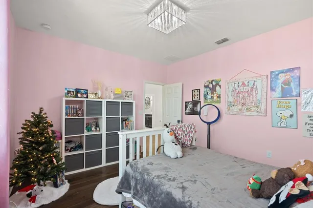 a bedroom with a bed and a chandelier