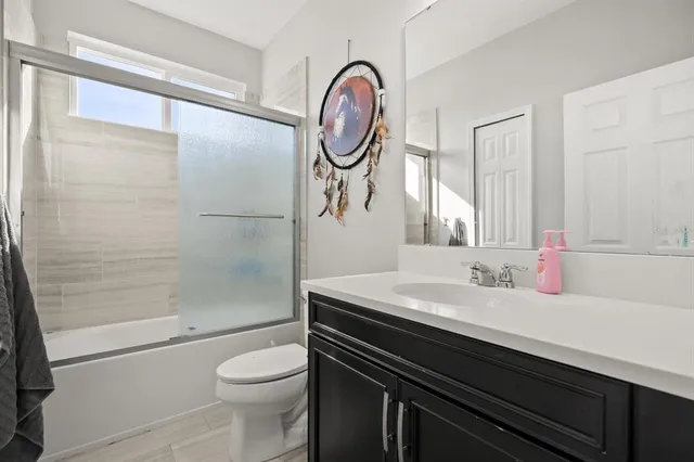 a bathroom with a sink a toilet and a shower