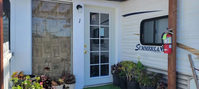 a front view of a house with a potted plant