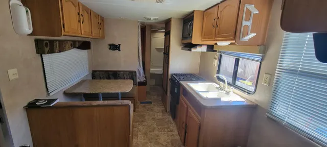 a living room with a bed furniture and a window
