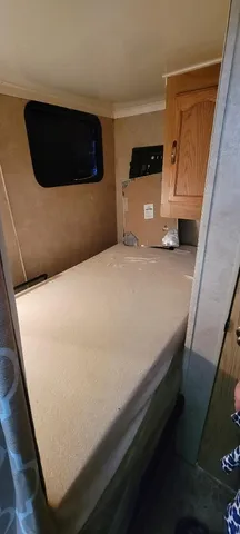 a bedroom with a bed and a mirror