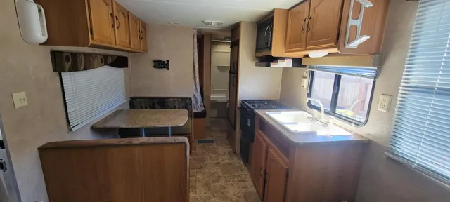 a kitchen with stainless steel appliances granite countertop a stove a refrigerator and a cabinets