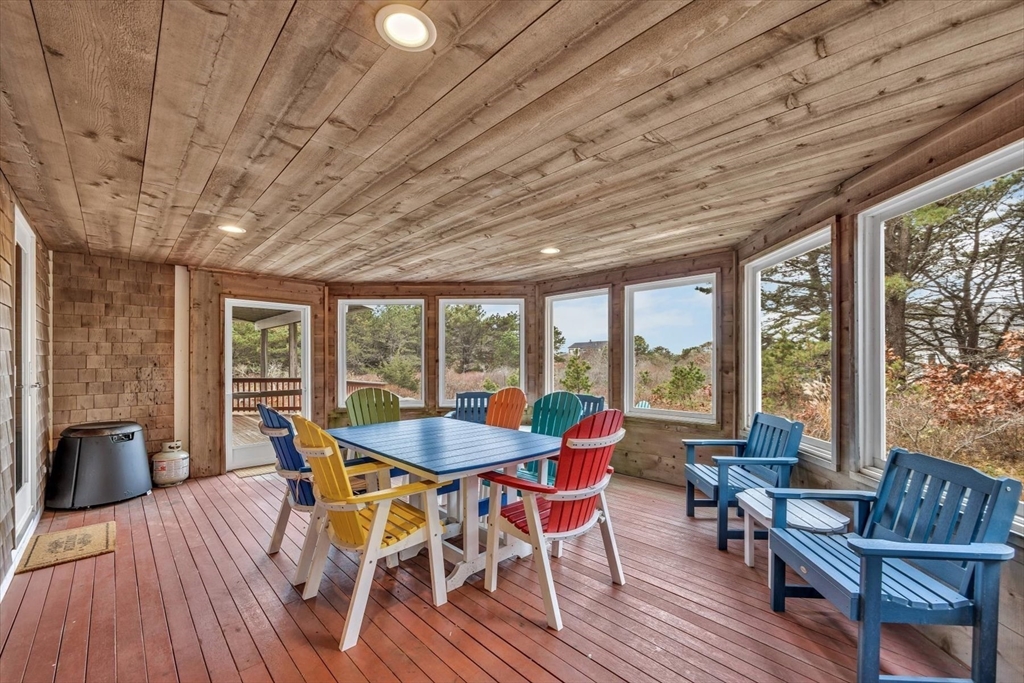 128 Shore Road Truro, MA 02666 - Photo 19 of 42 a dining room with furniture window wooden floor