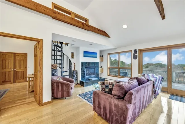 a living room with furniture and a floor to ceiling window