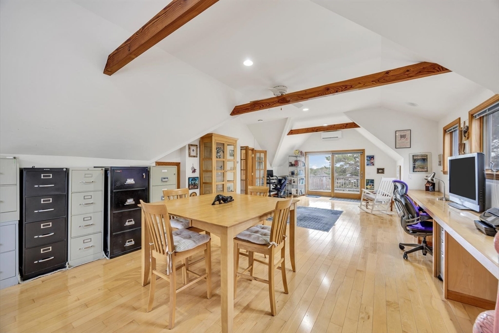 128 Shore Road Truro, MA 02666 - Photo 29 of 42 a living room with furniture a flat screen tv and kitchen view