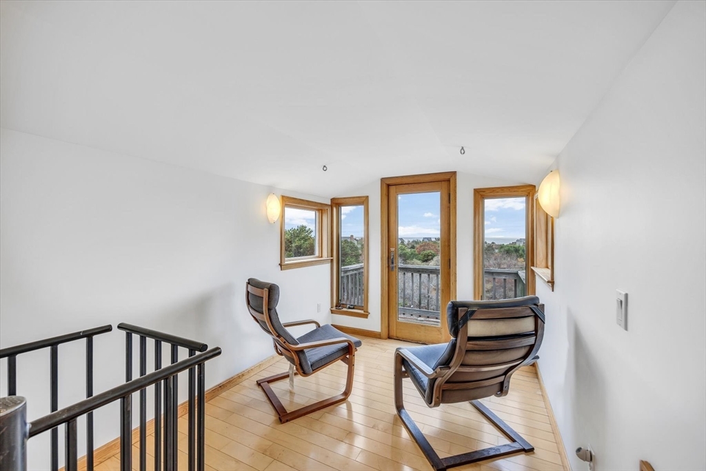 128 Shore Road Truro, MA 02666 - Photo 32 of 42 a living room with furniture and a floor to ceiling window