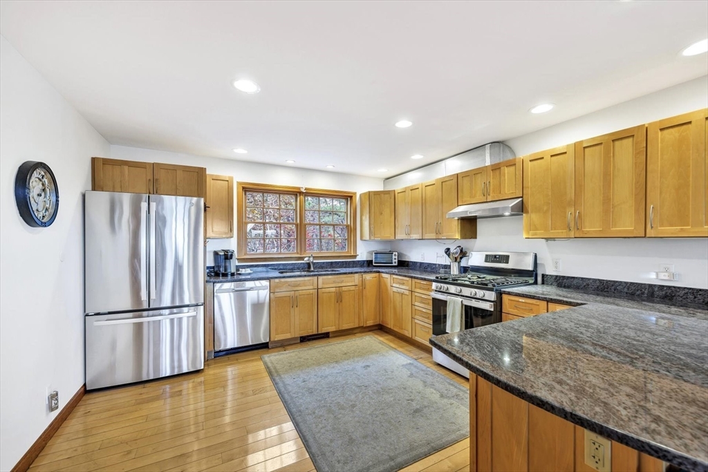 128 Shore Road Truro, MA 02666 - Photo 8 of 42 a kitchen with stainless steel appliances granite countertop a refrigerator a stove top oven a sink and dishwasher