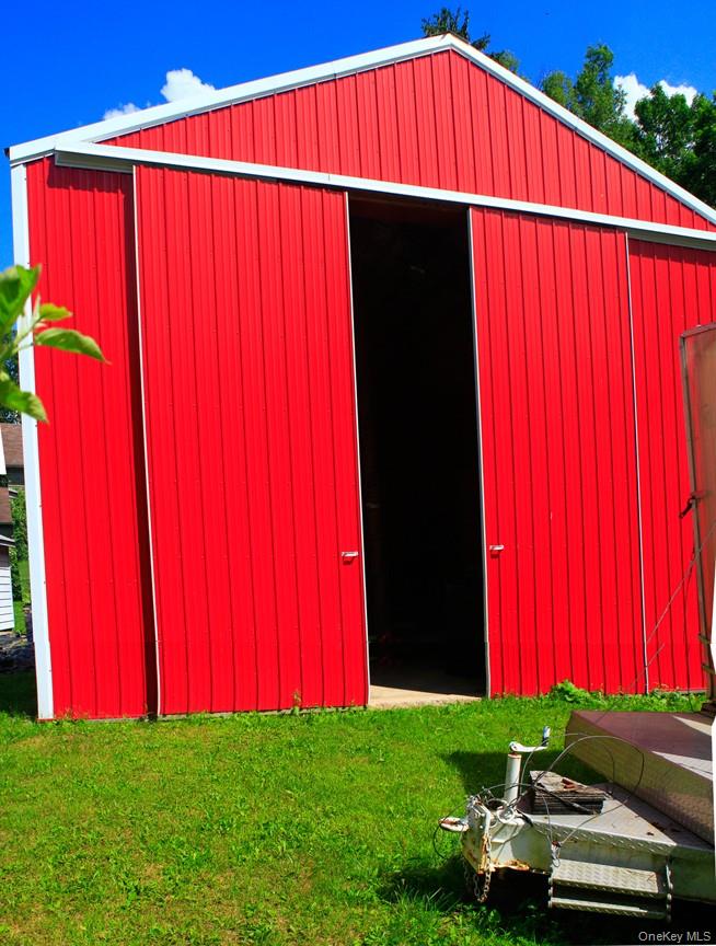 876 North Branch Road North Branch, NY 12766 - Photo 19 of 27 a view of a backyard with an umbrella and wooden fence
