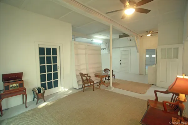 a living room with furniture a window and a chandelier
