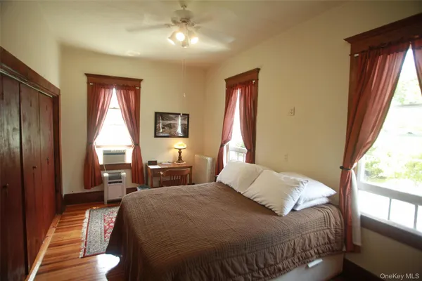 a bedroom with a large bed and a large window