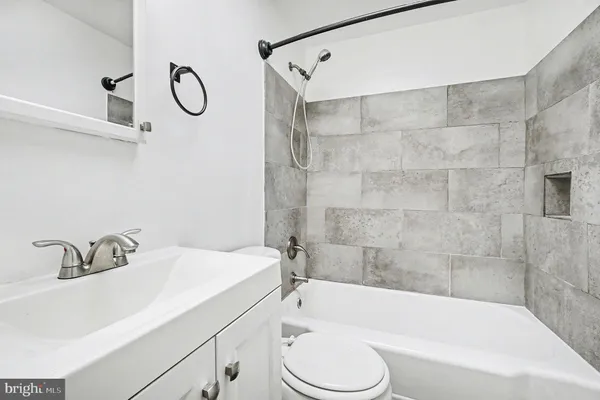 a bathroom with a sink a toilet and a bathtub