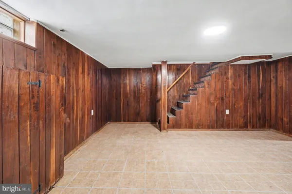 a view of an empty room with wooden walls