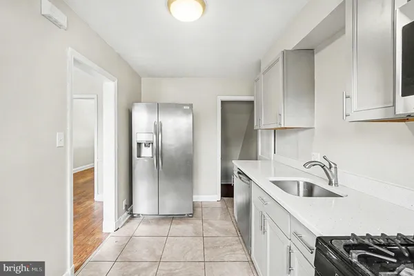 a kitchen with a sink and refrigerator