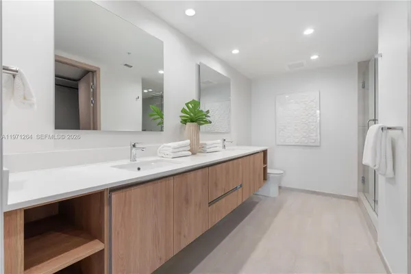 a bathroom with a double vanity sink and a mirror