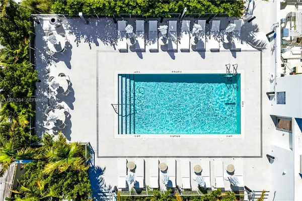 a view of a swimming pool with outdoor seating