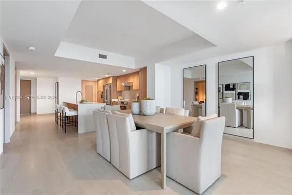 a living room with furniture a dining table and chairs