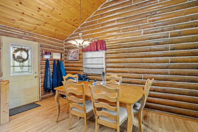 a dining room with furniture and wooden floor