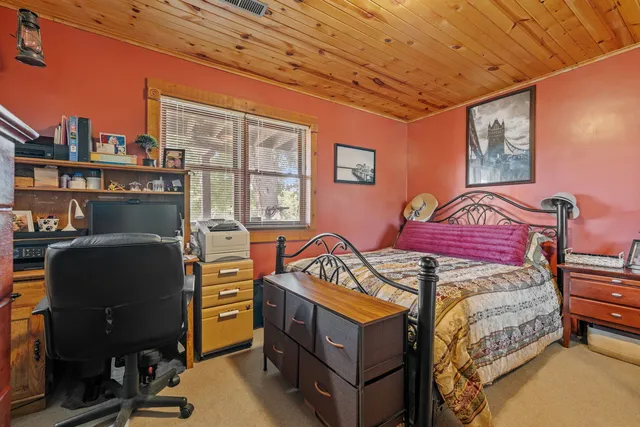 a bedroom with furniture and a window