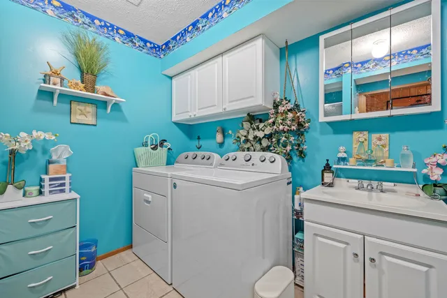 a utility room with sink dryer and washer