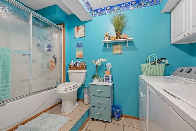 a bathroom with a toilet a sink and shower