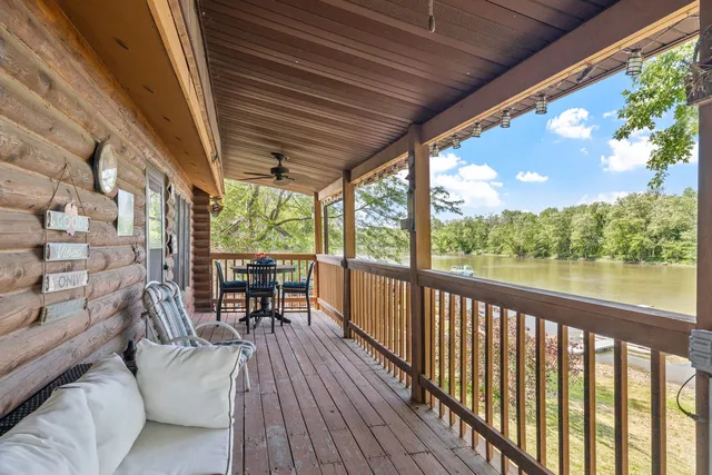 a view of balcony with chairs and wooden floor