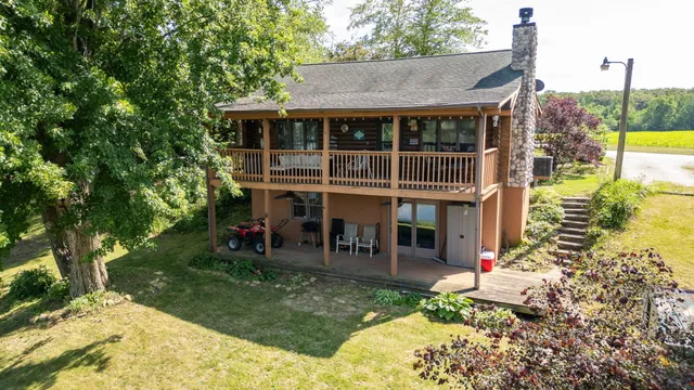 a view of a house with a backyard porch and sitting area