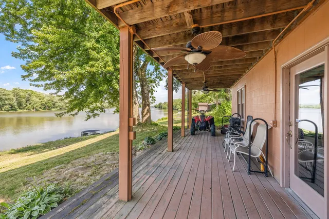 a view of a chairs and table in patio with wooden floor
