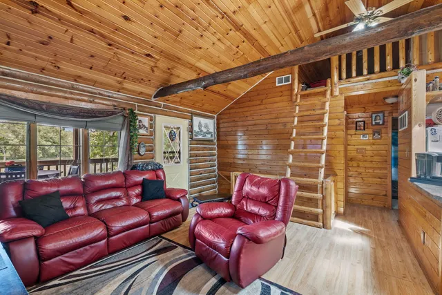 a outdoor living space with furniture and a ceiling fan