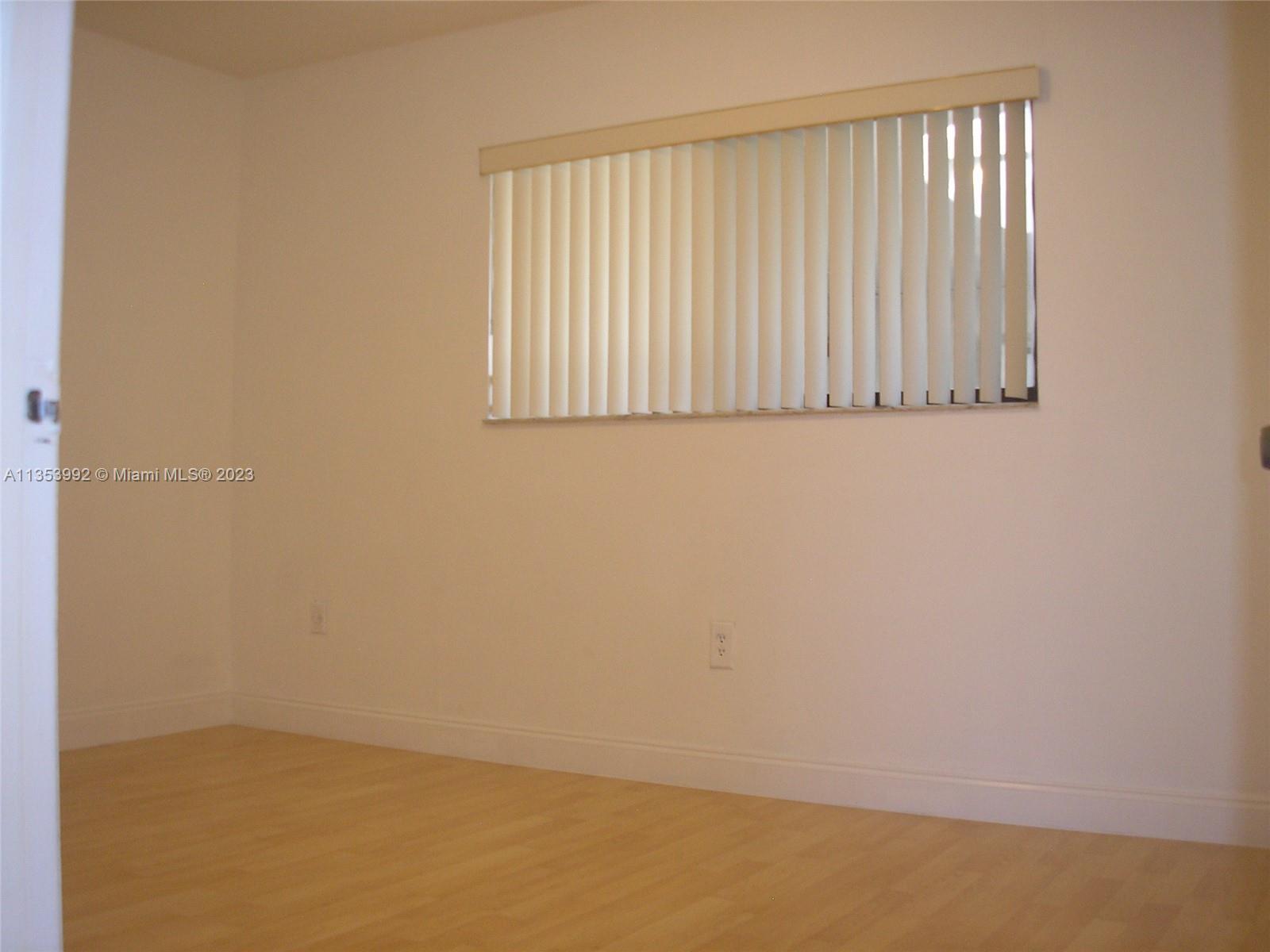8035 Southwest 107th Avenue, Unit 317 Miami, FL 33173 - Photo 12 of 17 an empty room with a window