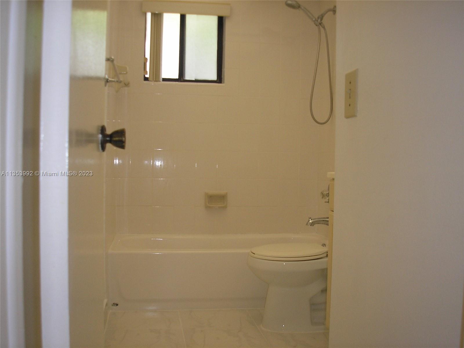 8035 Southwest 107th Avenue, Unit 317 Miami, FL 33173 - Photo 13 of 17 a bathroom with a shower and a toilet