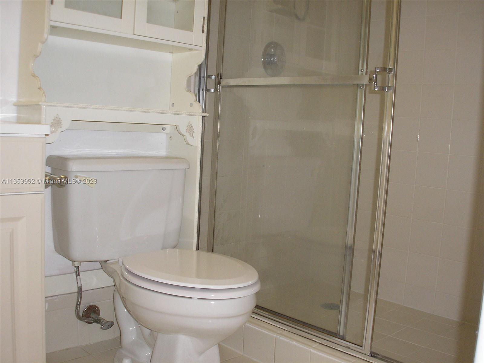 8035 Southwest 107th Avenue, Unit 317 Miami, FL 33173 - Photo 14 of 17 a bathroom with a toilet and a shower