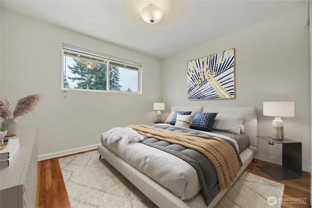 a bedroom with a bed and a painting on the wall