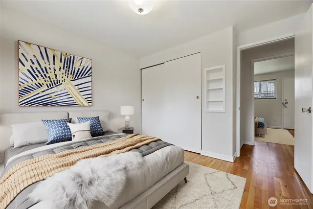 a bedroom with a bed and wooden floor