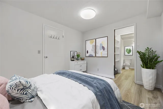 a bedroom with a bed and wooden floor