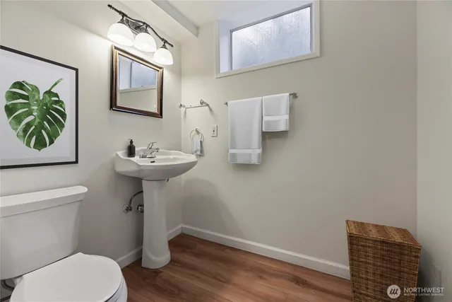 a bathroom with a toilet sink and mirror